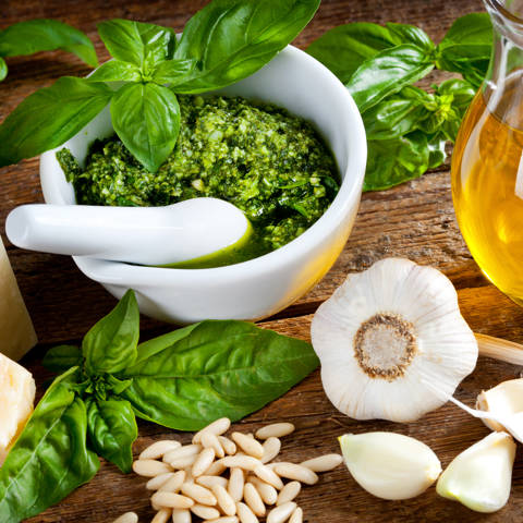 Ingredienserne til den klassiske pesto genovese på et bord.