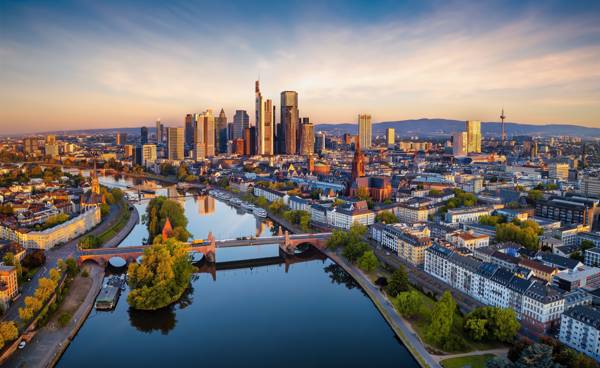 Luftfoto af Frankfurt am Main i Tyskland med Main-floden og byens skyline i solopgangen.